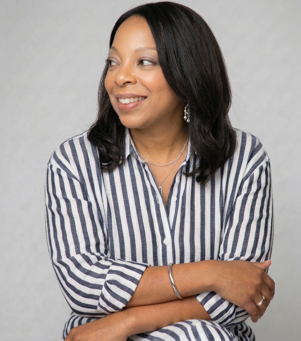 Smiling woman in striped shirt with folded arms